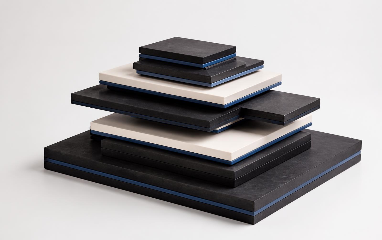 Stacked charcoal and off-white layers with blue edges representing technology stack architecture